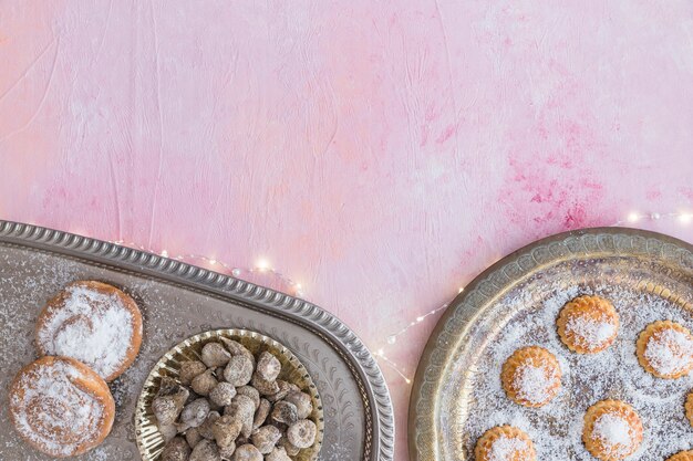 Assortment of sweets and lighting garland 