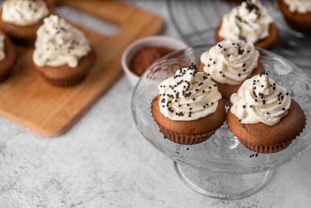 Assortment of tasty cupcakes on glass support