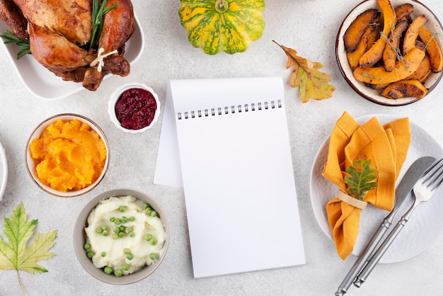 Assortment of thanksgiving day delicious dinner with notepad