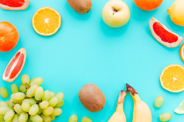 Assortment of tropical fruits on turquoise background