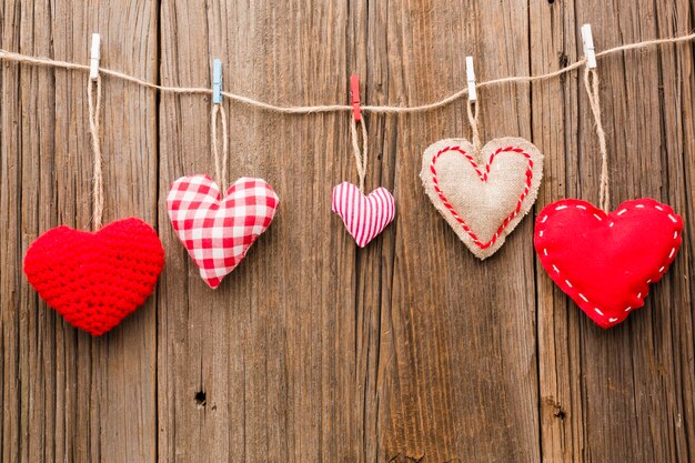 Assortment of valentines day ornaments on wooden background
