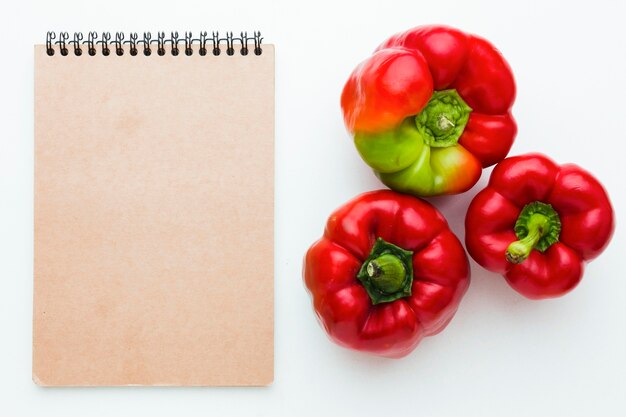 Assortment of vegetables on empty notepad