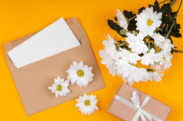 Ассортимент белых цветов с конвертом и подарком в упаковке