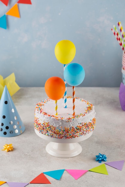 Assortment with cake and balloons high angle