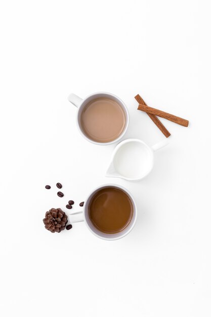 Assortment with coffee cups and cinnamon sticks