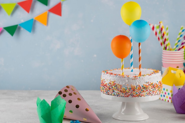 Assortment with delicious cake and balloons