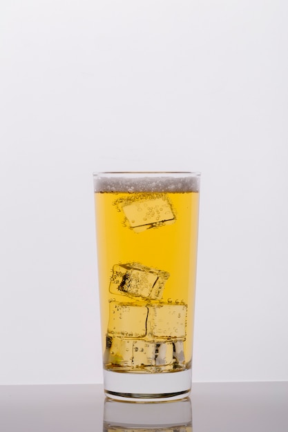 Assortment with glass of drink and ice cubes