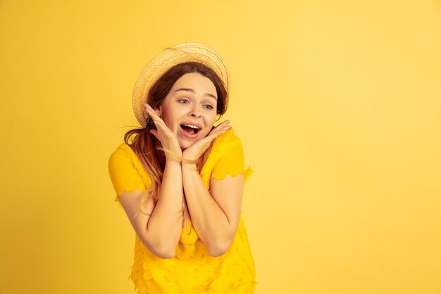 Astonished, shocked, cute beautiful female model in hat