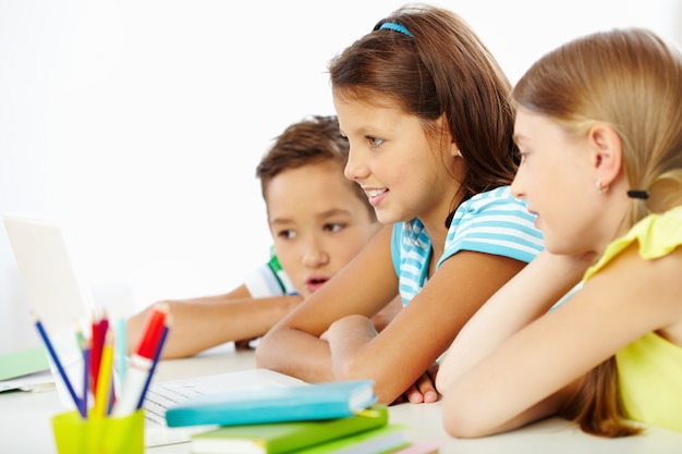 Astonished students with a laptop