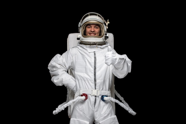 Astronaut day cosmonaut in galaxy space suit helmet successfully landed happy good hand gesture