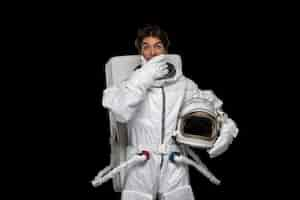 Free photo astronaut day cosmonaut in outer space galaxy cosmos surprised closed mouth open eyes helmet off