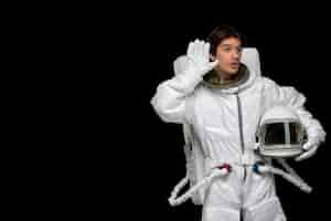 Free photo astronaut day curious spaceman in outer space cosmos galaxy helmet off hand on ear listening