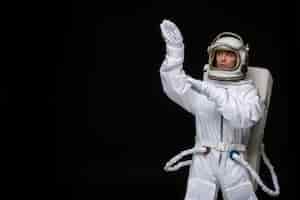 Free photo astronaut day spaceman in cosmos space suit landed on moon hands up