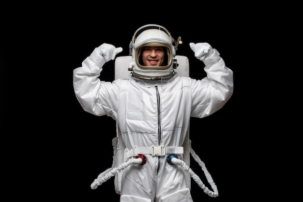 Astronaut day spaceman excited in outer space standing with fists up smiling open glass helmet