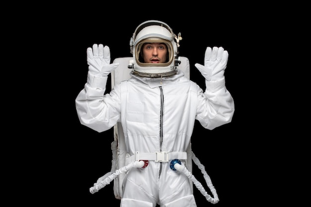 Astronaut day spaceman in galaxy outer space space suit helmet hands up afraid need help