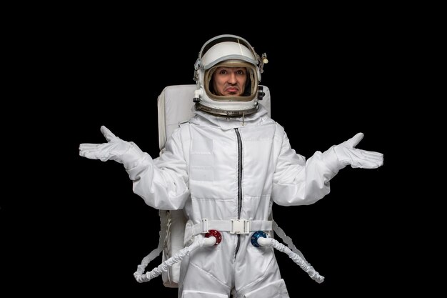 Astronaut day spaceman in galaxy space suit helmet waving hands confused outer space