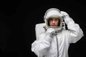 Free photo astronaut day spaceman taking off glass helmet in space suit in outer space cosmos galaxy