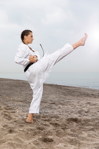 Athlete female training in karate outfit