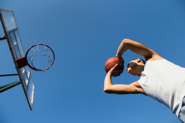 Athlete playing basketball low angle