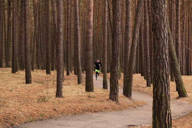 Athlete running in forest