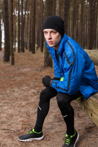 Athlete sitting in woods