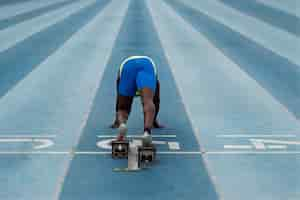 Free photo athlete on the starting line at the stadium