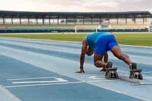 Free photo athlete on the starting line at the stadium