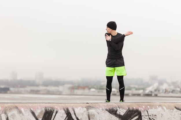 Athlete stretching on a grey day