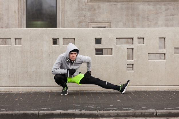 Athlete stretching in urban environment