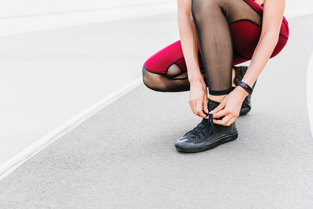 Athlete tying her shoe laces