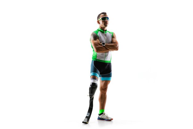 Athlete with disabilities or amputee isolated on white studio background. Professional male runner with leg prosthesis training and practicing in studio. Disabled sport and healthy lifestyle concept.