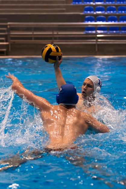 Athletes playing water polo in the pool