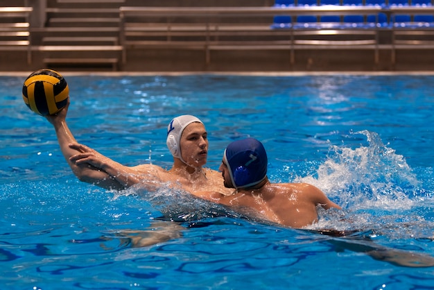 Athletes playing water polo in the pool