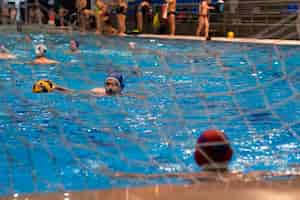 Free photo athletes playing water polo in the pool