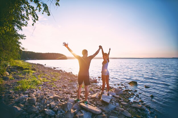 Athletes raising arms outdoors