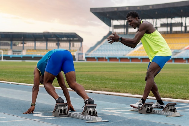 Free photo athletes on the starting line at the stadium