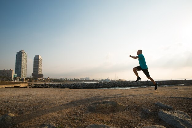 Athletic city guy running in morning