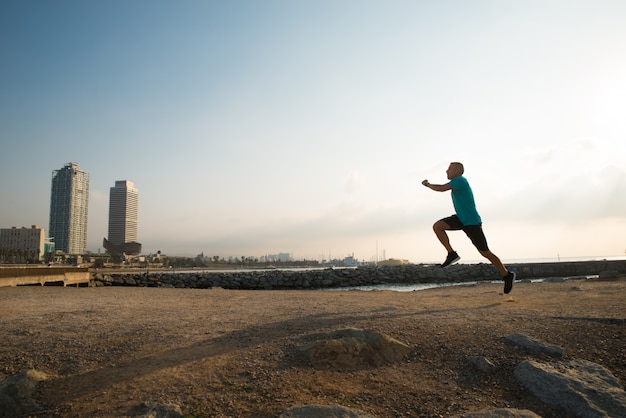 Athletic city guy running in morning