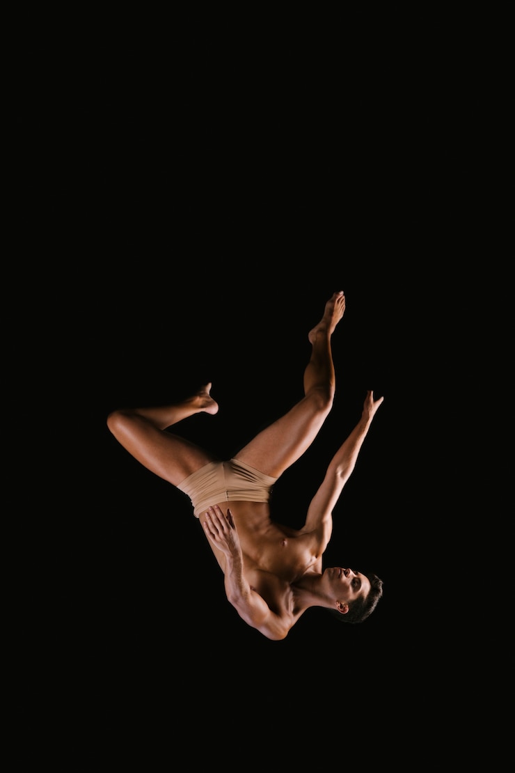 Free Photo athletic male exercising on black background