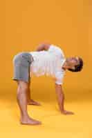 Free photo athletic man doing yoga exercise