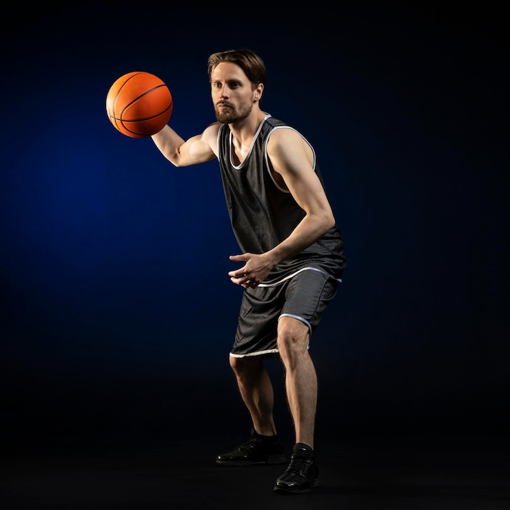Free Photo athletic man holding a basketball