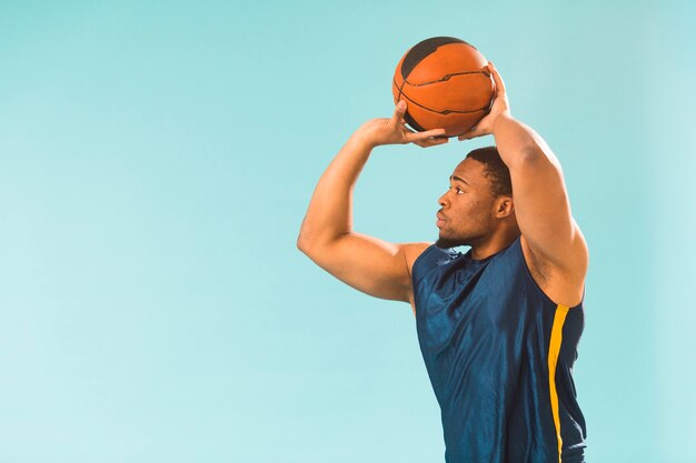 Athletic man playing basketball