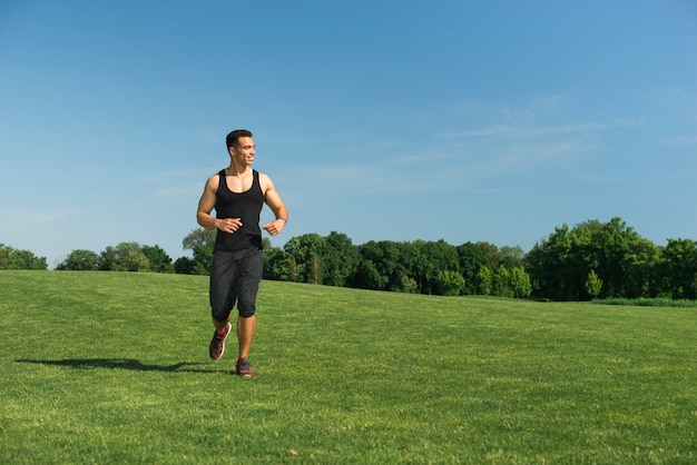 Athletic man running outdoor in a park