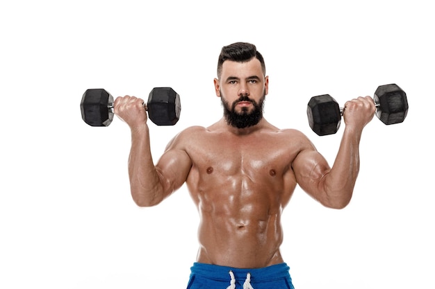Athletic muscular man doing exercises with dumbbells. strong bodybuilder with naked torso on white background