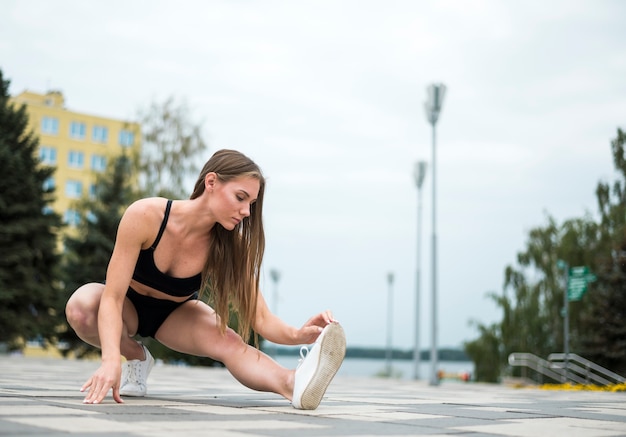 Athletic woman doing exercises  long shot