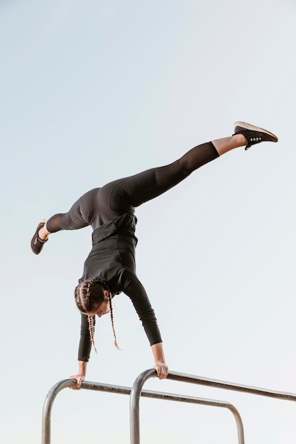 Athletic woman doing exercises outdoors with copy space