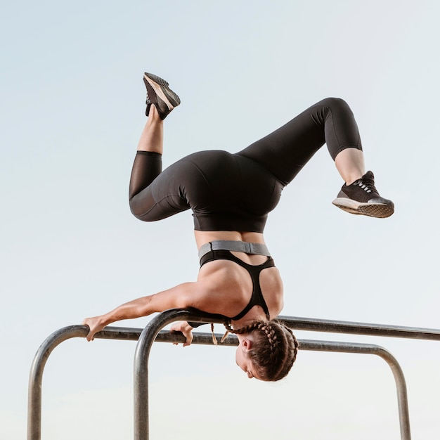 Athletic woman doing fitness exercises outdoors