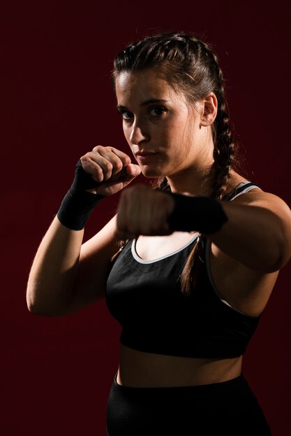 Athletic woman in fitness clothes giving a punch
