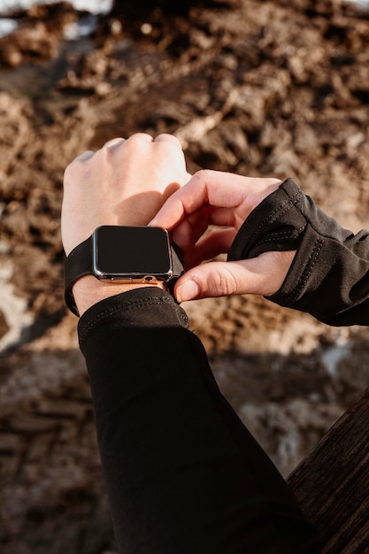 Athletic woman fixing her smartwatch