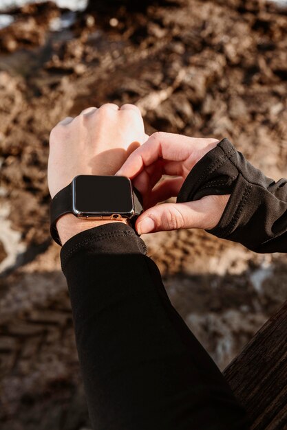 Athletic woman fixing her smartwatch